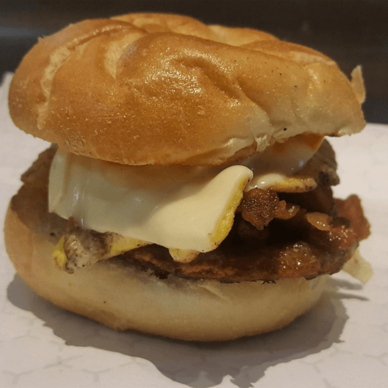 The Hungry Chicken Country Store Bacon, Egg and Cheese Breakfast Sandwich On A Kaiser Roll.